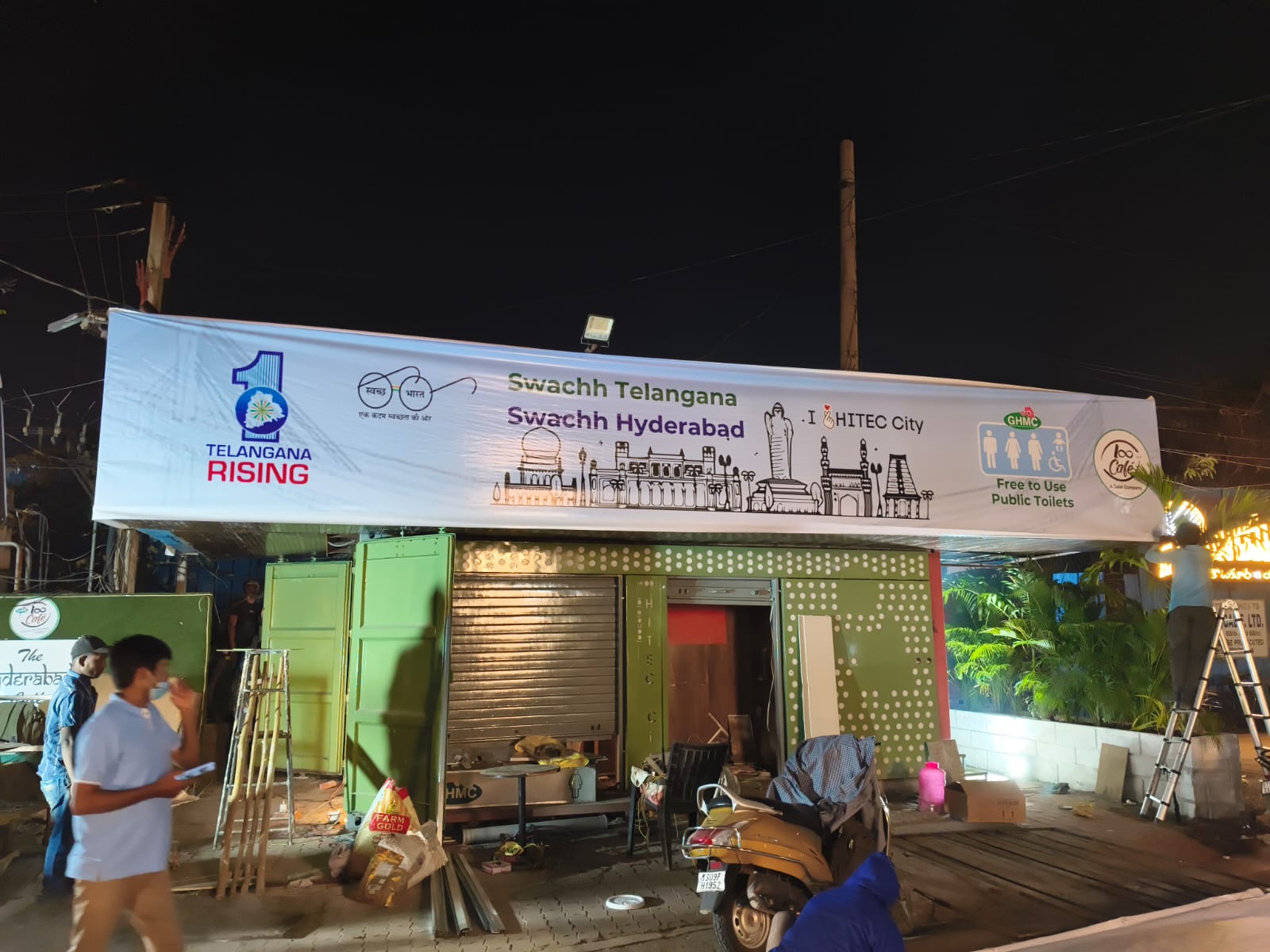 Loo Café unit at night with public-sanitation signage