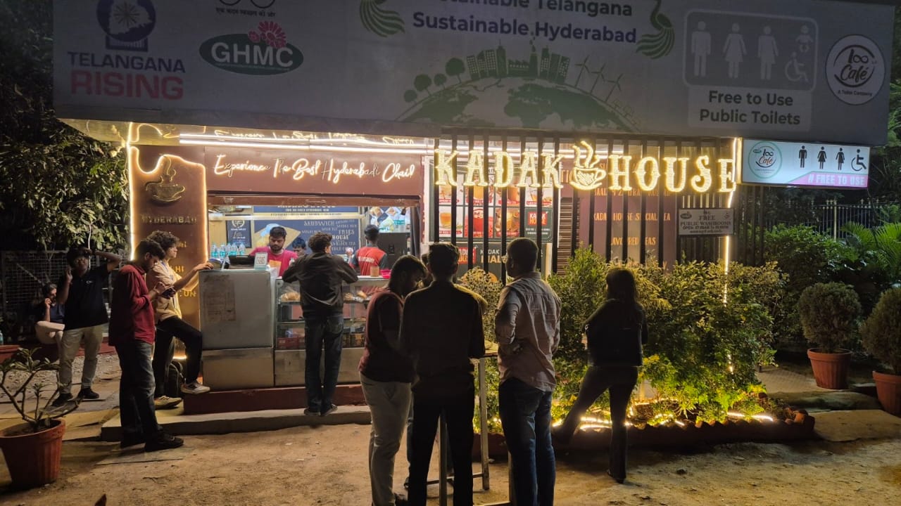 Loo Café at night with public-sanitation signage above the entrance